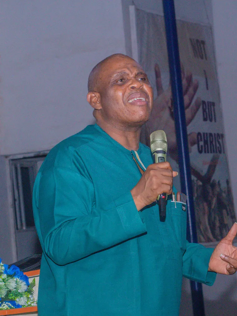 Lekan Asikhia preaching with a microphone