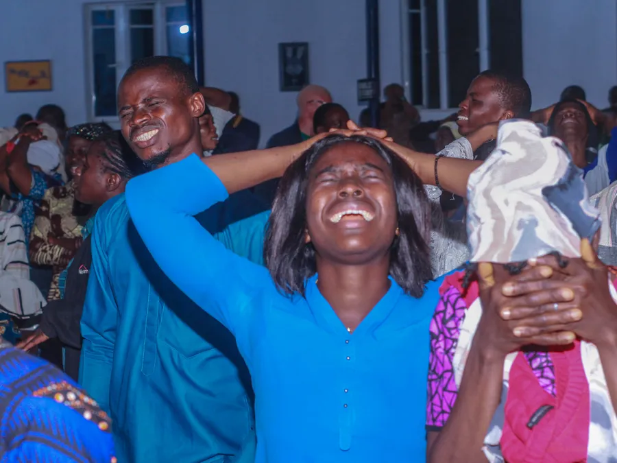Worshippers praying with hands lifted